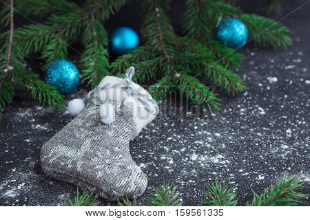 Christmas Grey Stocking On Snowbound Black Background With Blue Balls