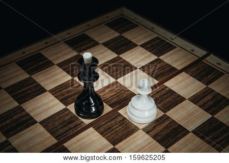 White pawn against the black king on the chessboard