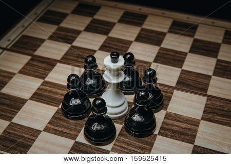 white King, surrounded, by, pawns, on, the, board