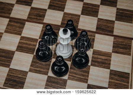 white King, surrounded, by, pawns, on, the, board