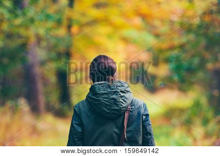 Rear View Of Woman In Colorful Autumn Forest.
