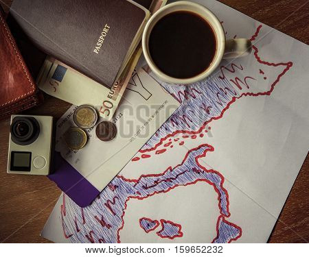passport banknote boarding pass and camera on table top and europe map