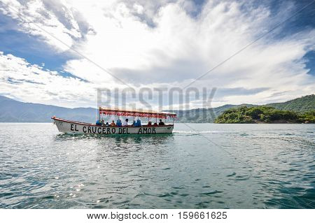 Lake Coatepeque El Salvador - May 23 2015: Tourist boat cruises the waters of the beautiful volcanic caldera Lake Coatepeque in El Salvador. Central America