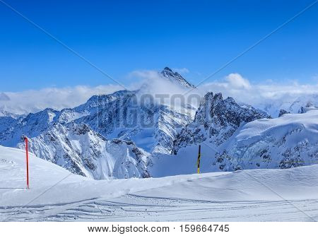 View from Mt. Titlis in the Swiss Alps in winter. Mount Titlis is a mountain located on the border between Swiss Cantons of Obwalden and Bern.