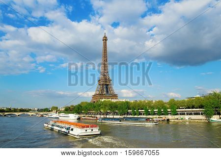 Eiffel Tower With Touristic Boat On Seine