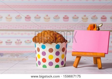 homemade muffins in colorful holders on the day of the birthday celebration. Kapka for children and women. blank sheet for writing your text