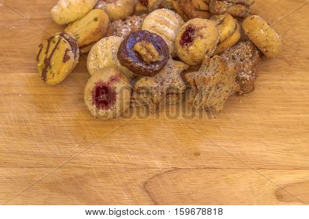 Several christmas cookies on rustic wooden plate
