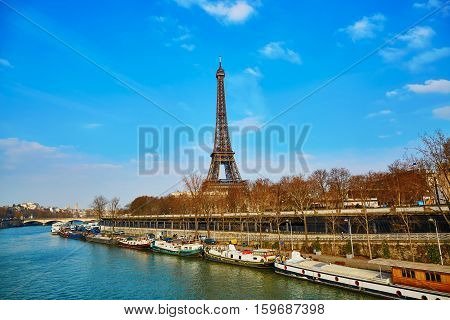 Scenic view of the Eiffel tower across the Seine on an early spring day
