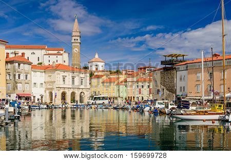 Piran, Slovenia - September 19, 2016: a view of the city of Piran with beautiful old buildings and boats in the Harbor. Piran is one of Slovenia's major tourist attractions.
