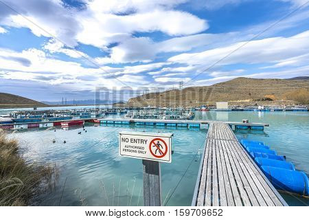 Salmon Fish farm floating on the glacial waters of Wairepo Arm Twizel South Island New Zealand