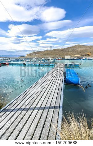 Salmon Fish farm floating on the glacial waters of Wairepo Arm Twizel South Island New Zealand
