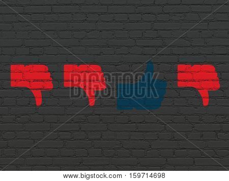 Social network concept: row of Painted red thumb down icons around blue thumb up icon on Black Brick wall background