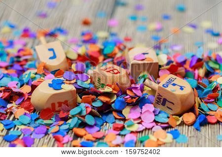 wooden dreidels spinning top for hanukkah jewish holiday over glitter gold background