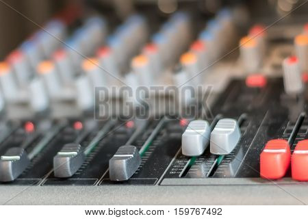 close up electronic professional sound mixer control panel in music studio with channel console and media button for record music or live radioselective focus.