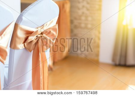 beautiful chairs decoration with ribbon in wedding event hallselective focus.