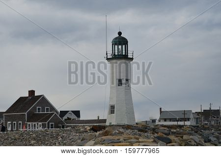 Over cast skies and clouds hanging over Old Scituate Light in Massachusetts.