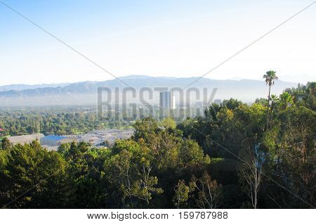 Forest hotel in the middle and mountains in background