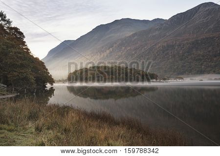Beautiful Autumn Fall Landscape Image Of Crummock Water At Sunrise In Lake District England