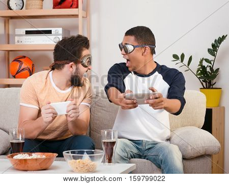 Picture of happy friends playing computer games. Handsaome men screaming and shouting, looking at each other during plating games. Computer games concept.