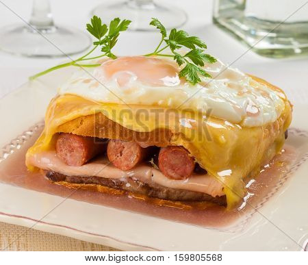 Francesinha on plate typical food from Porto Portugal. With fried egg.