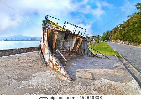 wreck boat on the road at Eleusis Greece