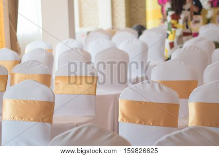 beautiful chairs decoration with ribbon in wedding event hallselective focus.
