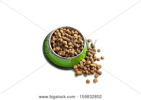 Dry dog food in a metal dog bowl green. Oval dog food croquettes. Isolate on white background.