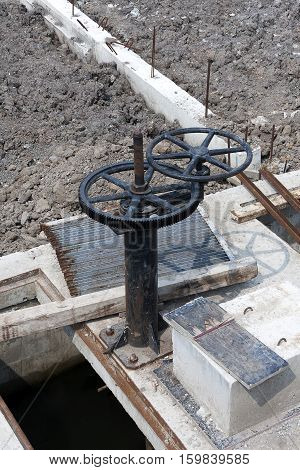 Irrigation Canal and old rusty Floodgate valve