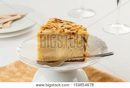 Madame Pompadour cake covered with almonds on a cake stand.