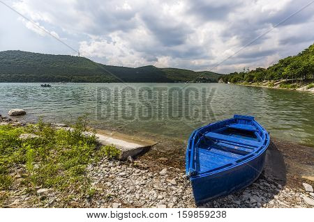 Nice view of Abrau-Durso Lake in Caucasus mountains in Russia with boat on foreground