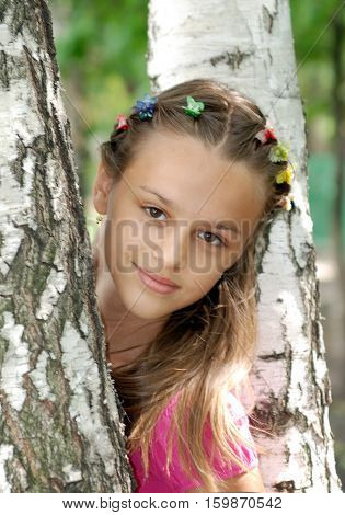 naughty country girl posing for a photograph among birches