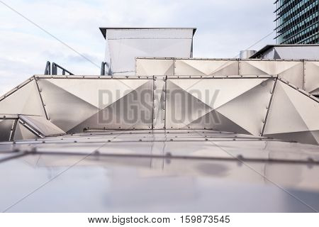 ventilators on the roof of a tall building in the industrial area