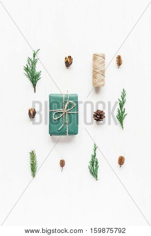 Christmas composition with pine cones cypress branches christmas gift. Top view flat lay