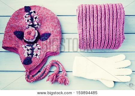 Winter wool hat, folded scarf and white gloves