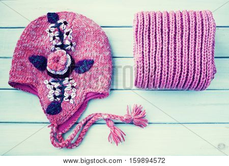 Winter wool hat and folded pink scarf