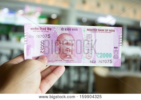 Man hold 2000 rupee banknote on mall background it is the new reveal by reserve bank of India
