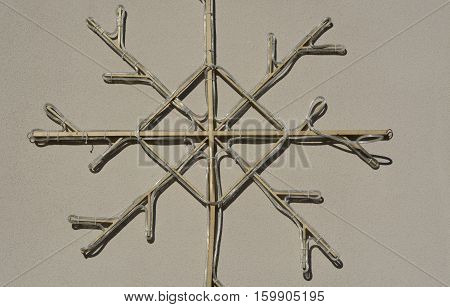 Holiday Christmas lights in shape of snowflake on wall