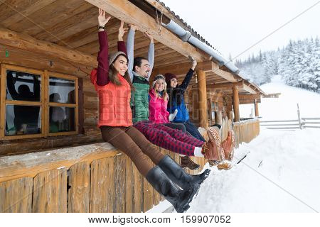 People Group Sitting On Terrace Wooden Country House Winter Snow Resort Cottage Friends Communication Vacation