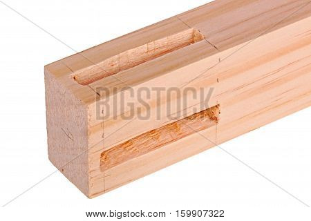 Close-up of the end of a pine board with two freshly cut woodworking mortises isolated against a white background