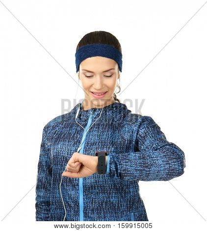 Beautiful young woman in warm clothes with pulsometer on white background