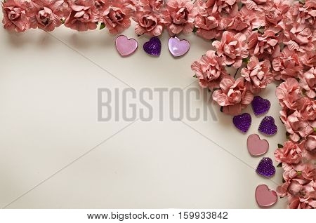 beautiful card for the holiday of love. Background for Valentine's Day. Postcard for weddings. Pink flowers on a white background scattered small hearts.