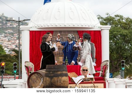 FUNCHAL MADEIRA PORTUGAL - SEPTEMBER 4 2016: Men in historical fashion dress raise toasts durnig historical and ethnographic parade of Madeira Wine Festival in Funchal. Madeira Portugal