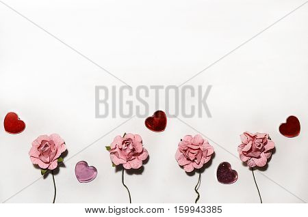 beautiful card for the holiday of love. Background for Valentine's Day. Postcard for weddings. Pink flowers on a white background scattered small hearts.