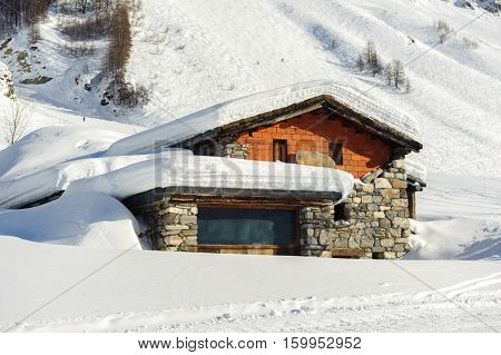 Alpine winter mountain landscape. French Alps covered with snow in sunny day. Val-d'Isere, France