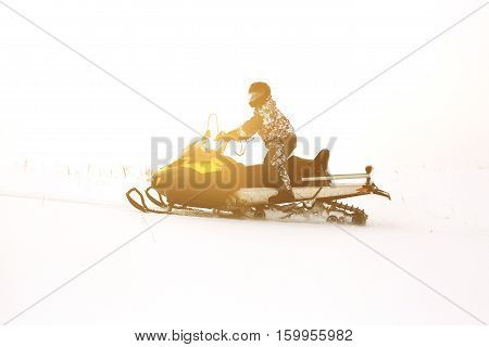Man on snowmobile. Recreation concept on nature in winter holidays. Winter sports.