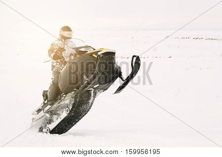 Man on snowmobile. Recreation concept on nature in winter holidays. Winter sports.