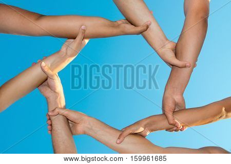 Hands forming an unbreakable chain against the sky