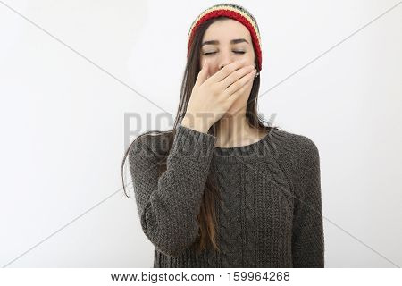 Portrait of tired hipster girl who yawns