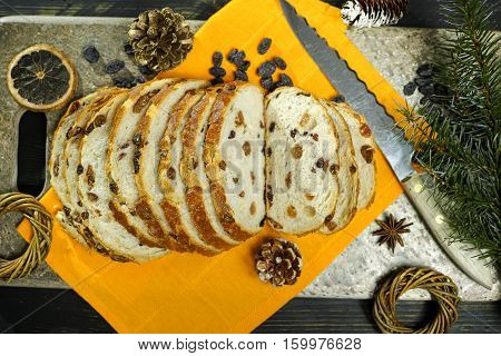 Fresh baked raisins bread sliced on granite board holiday concept