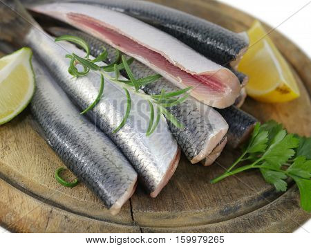 fishes herrings with lemon on a chopping board